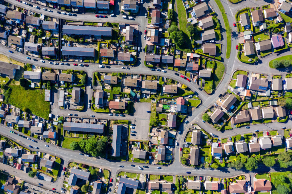 Aerial drone view of small winding sreets and roads in a residential area of a small town